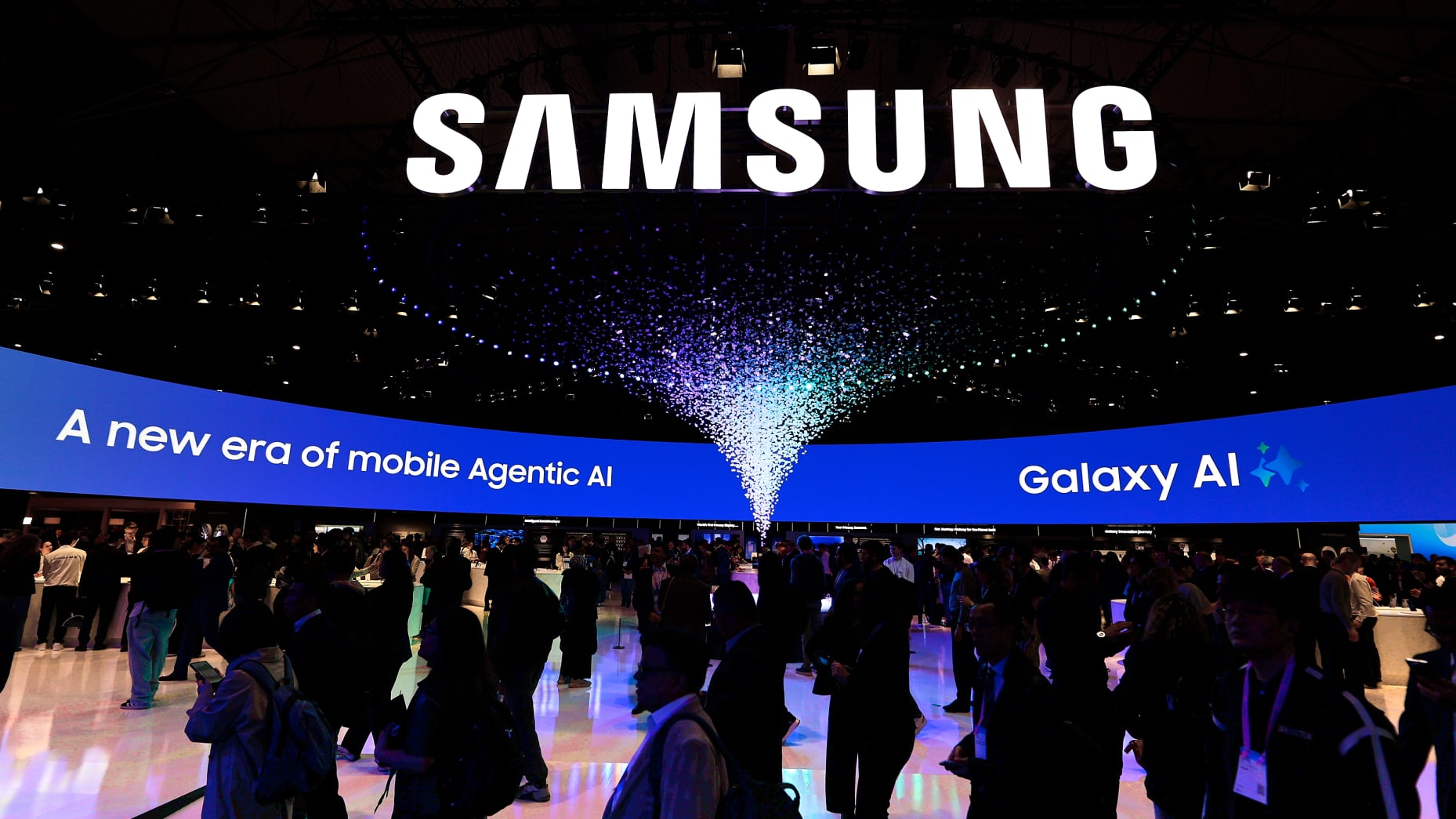 The Samsung exhibition stand features the prominent ''A new era of mobile agentic AI'' slogan by the South Korean company Samsung Electronics. It highlights the integration of the Snapdragon 8 Gen 5 Mobile Platform and advanced Galaxy AI features into their latest ecosystem of devices. Attendees interact with the new technology during the Mobile World Congress (MWC) in Barcelona, Spain, on March 4, 2026. (Photo by Joan Cros/NurPhoto via Getty Images)