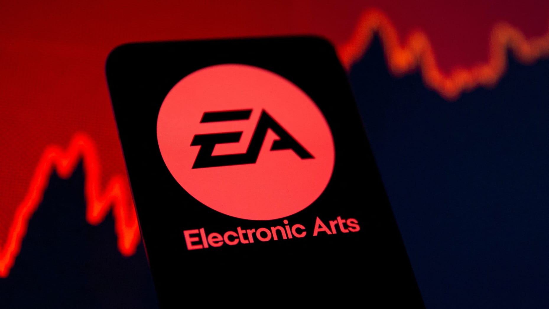 FILE PHOTO:A smartphone with the Electronic Arts logo is seen in front of a displayed stock graph in this illustration taken September 16, 2021. REUTERS/Dado Ruvic/Illustration/File Photo